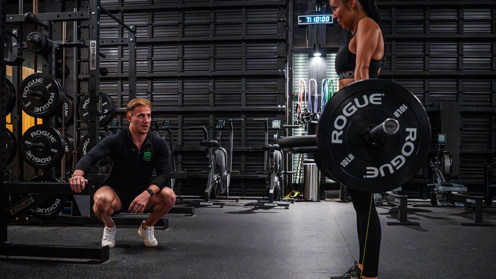 Damjan watching a client set up a deadlift on the training floor